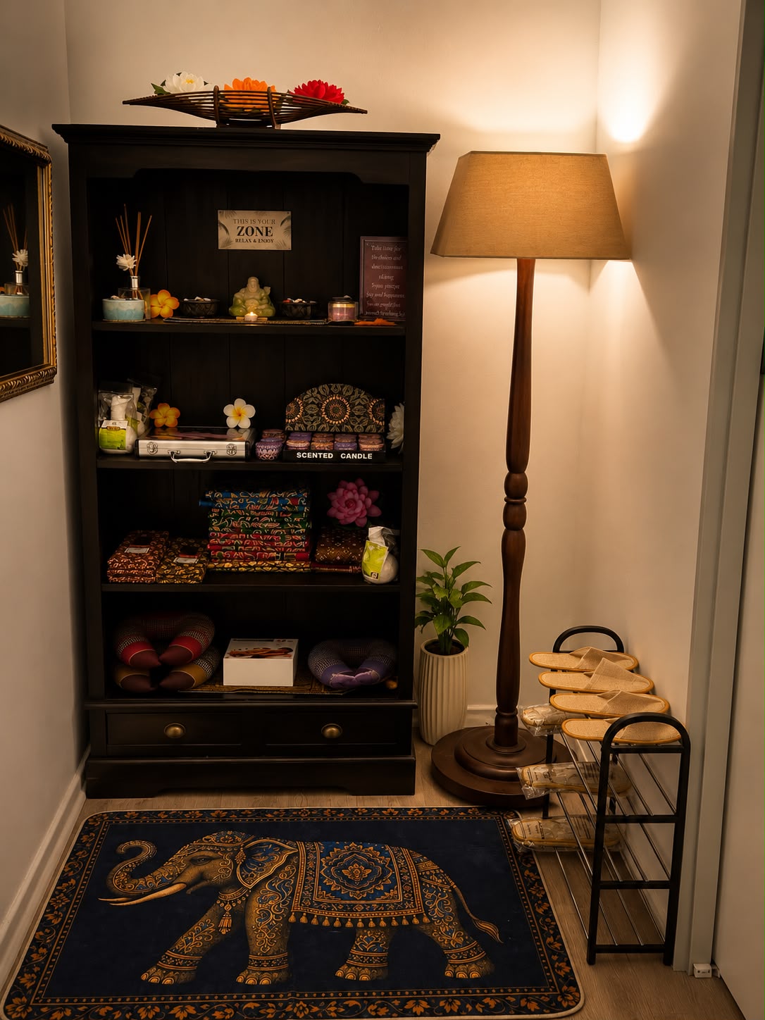 Retail nook with scented candles, Thai cushions, slippers and an elephant rug