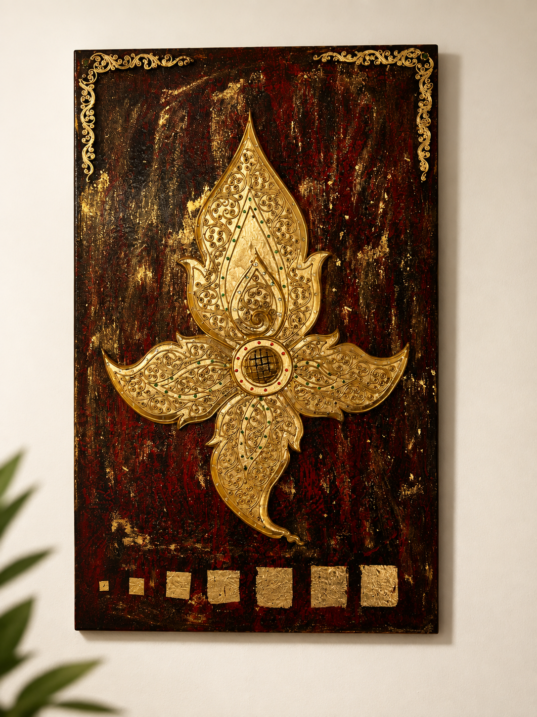Ornate golden Thai lotus motif carved and gilded on a dark red wooden wall panel with traditional corner flourishes